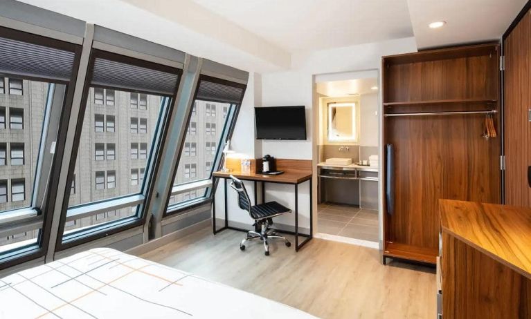 Guest room in La Quinta Times Square South, with workspace and ensuite bathroom.