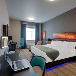 Comfortable king room with work desk and TV at Hotel Clique Calgary Airport.