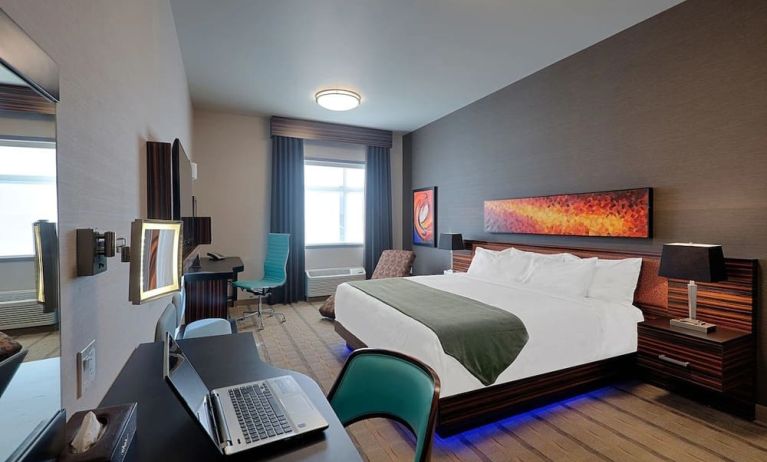 Comfortable king room with work desk and TV at Hotel Clique Calgary Airport.