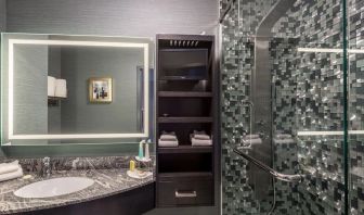 Spacious guest bathroom with shower at Hotel Clique Calgary Airport.