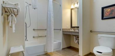 Guest bathroom with bath and shower combo at Comfort Suites Alexandria, LA.