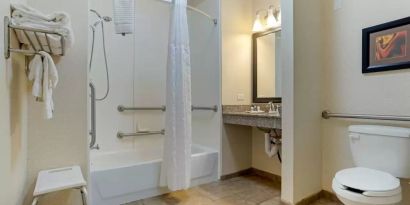 Guest bathroom with bath and shower combo at Comfort Suites Alexandria, LA.