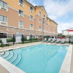 Stunning outdoor pool with seating area at Hawthorn Suites By Wyndham Longview.