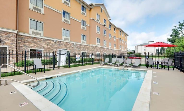 Stunning outdoor pool with seating area at Hawthorn Suites By Wyndham Longview.