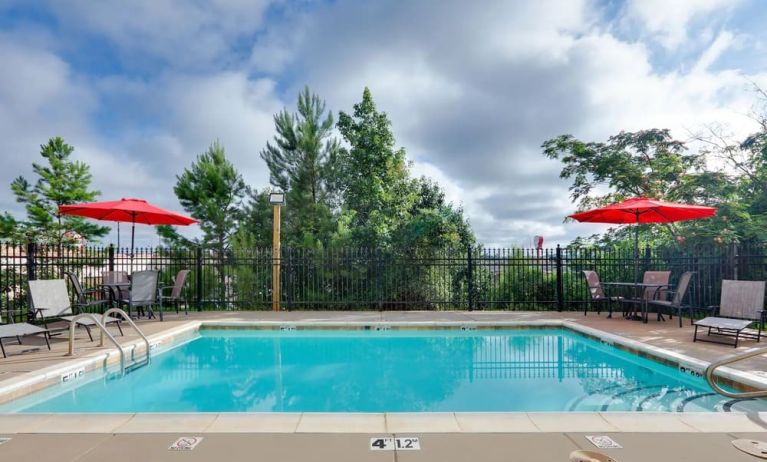 Large pool with sunbeds at Hawthorn Suites By Wyndham Longview.