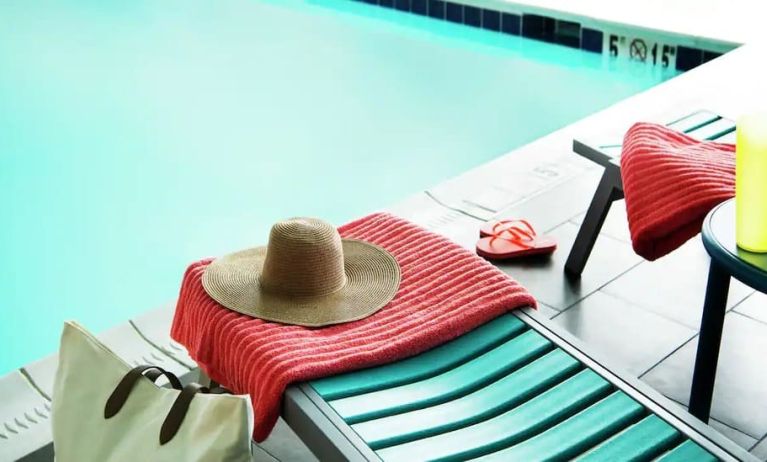 Lovely pool area with seating at Home2 Suites By Hilton Dallas Medical District Lovefield.