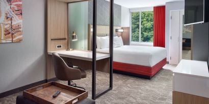 Spacious king room with TV and business desk at SpringHill Suites Atlanta Northwest.