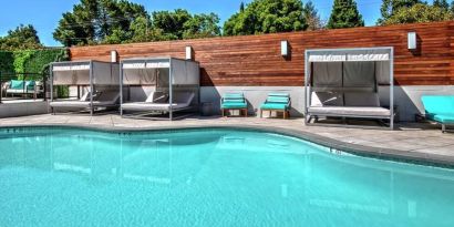 Relaxing pool area with cabanas at Hampton Inn Vallejo.