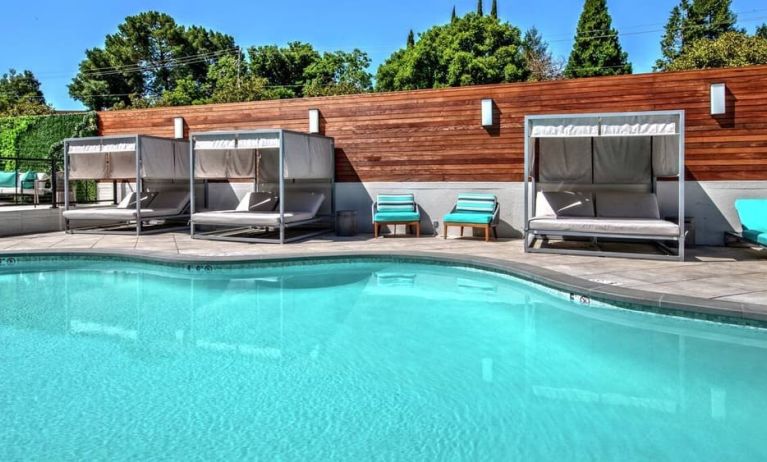 Relaxing pool area with cabanas at Hampton Inn Vallejo.