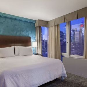 King bedroom with city views at Hilton Garden Inn New York/West 35th Street.