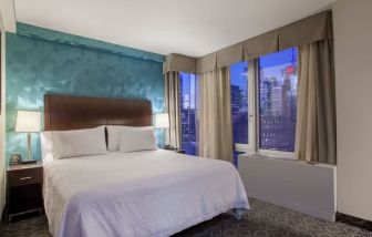 King bedroom with city views at Hilton Garden Inn New York/West 35th Street.