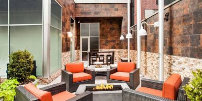 Cozy coworking space with fire pit at Hilton Garden Inn New York/West 35th Street.