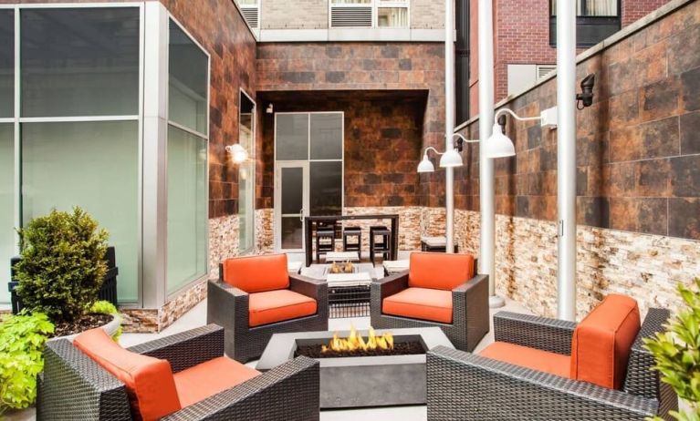 Cozy coworking space with fire pit at Hilton Garden Inn New York/West 35th Street.