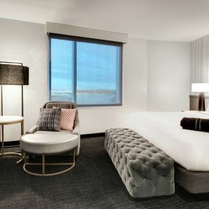 Spacious king bed with natural light at The Rose Hotel Chicago O’Hare, Tapestry Collection By Hilton.