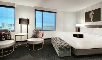 Spacious king bed with natural light at The Rose Hotel Chicago O’Hare, Tapestry Collection By Hilton.