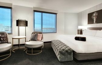 Spacious king bed with natural light at The Rose Hotel Chicago O’Hare, Tapestry Collection By Hilton.