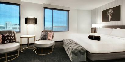 Spacious king bed with natural light at The Rose Hotel Chicago O’Hare, Tapestry Collection By Hilton.