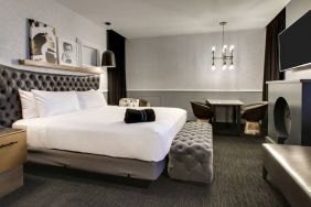 Spacious delux room with TV and seating area at The Rose Hotel Chicago O’Hare, Tapestry Collection By Hilton.