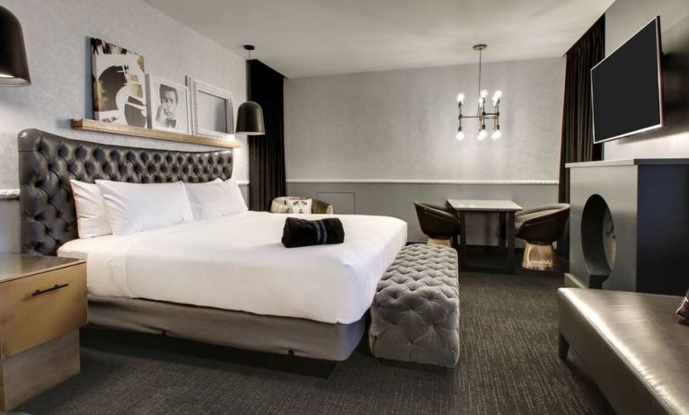 Spacious delux room with TV and seating area at The Rose Hotel Chicago O’Hare, Tapestry Collection By Hilton.