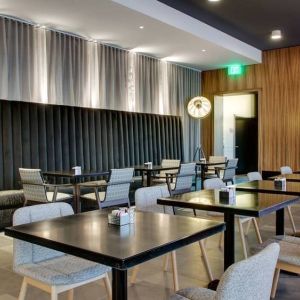 Comfortable coworking space and dining area at The Rose Hotel Chicago O’Hare, Tapestry Collection By Hilton.