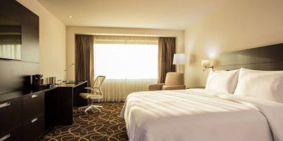 Lovely king bed with lots of natural light at Doubletree By Hilton Toluca.