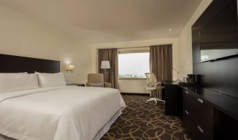 Delux king bed with TV and business desk at Doubletree By Hilton Toluca.