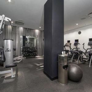 The NoMo Soho’s fitness center, with racked weights and various exercise equipment.