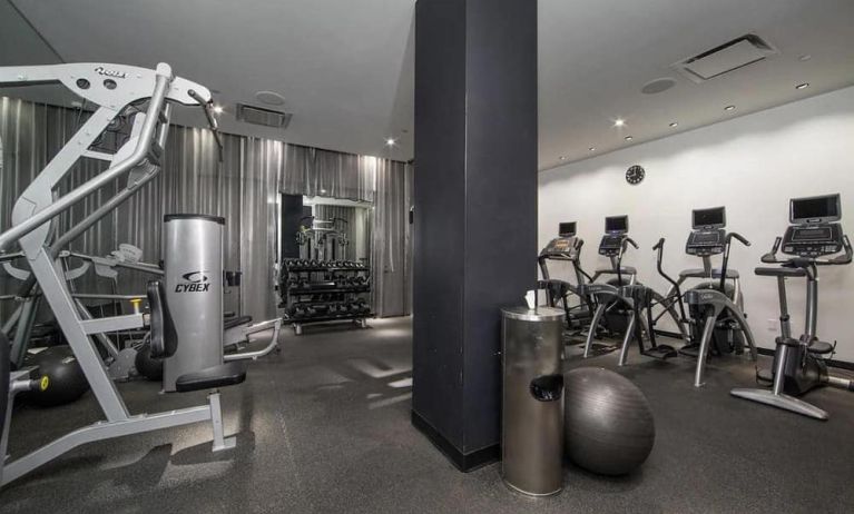 The NoMo Soho’s fitness center, with racked weights and various exercise equipment.