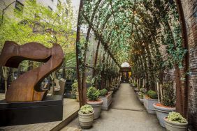 Vine covered trellis entryway leading to the lobby of the Nomo Soho in New York City.