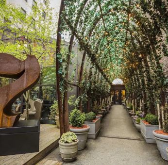 Vine covered trellis entryway leading to the lobby of the Nomo Soho in New York City.