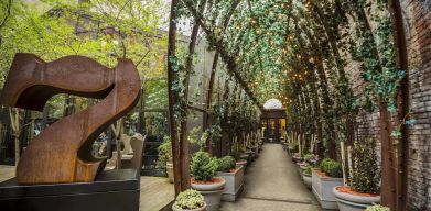 Vine covered trellis entryway leading to the lobby of the Nomo Soho in New York City.