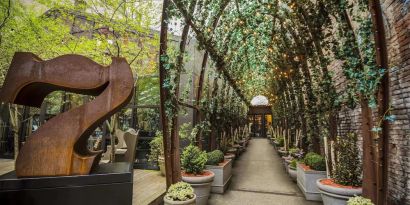 Vine covered trellis entryway leading to the lobby of the Nomo Soho in New York City.