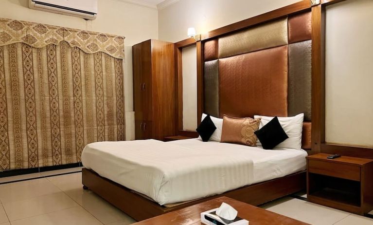 King bedroom with air conditioning at The Grand Hotel Multan.