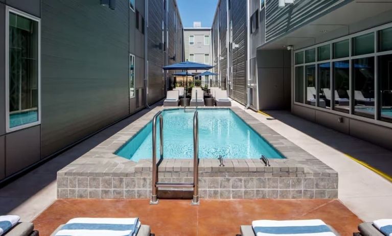 Stunning outdoor pool with sun beds at Homewood Suites By Hilton New Orleans French Quarter.