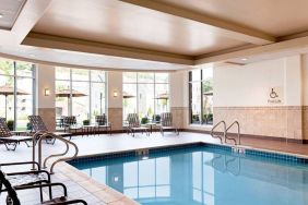 Stunning indoor pool with seating area at Hilton Garden Inn Boston Logan Airport.