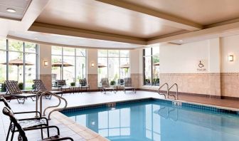 Stunning indoor pool with seating area at Hilton Garden Inn Boston Logan Airport.