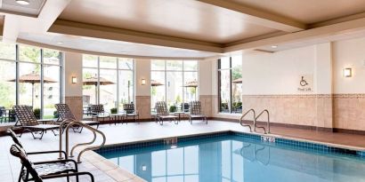 Stunning indoor pool with seating area at Hilton Garden Inn Boston Logan Airport.