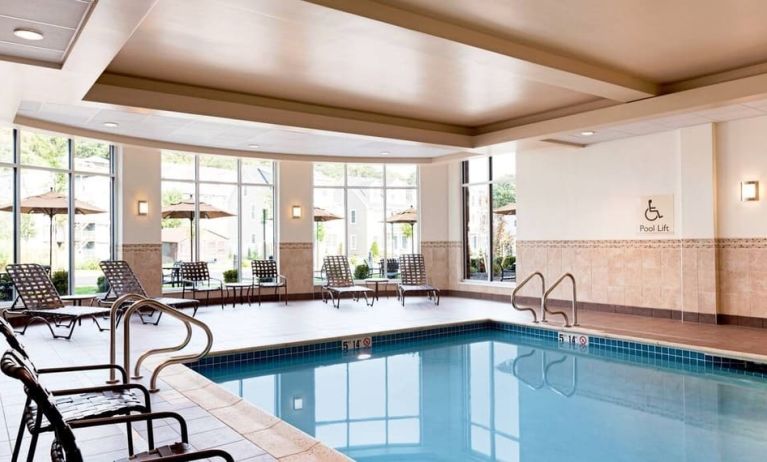 Stunning indoor pool with seating area at Hilton Garden Inn Boston Logan Airport.