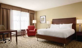 Spacious delux king bed with TV and work desk at Hilton Garden Inn Boston Logan Airport.