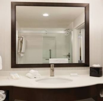 Private guest bathroom with shower at Hilton Garden Inn Boston Logan Airport.