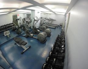 The hotel’s fitness center includes multiple exercise machines and an assortment of stacked weights.