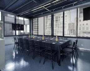 The Shoreham ‘s Atrium Loft Penthouse meeting facility, including long table and surrounding chairs.
