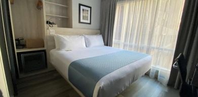 Guest room in the Wingate By Wyndham New York Midtown South/5th Ave, with double bed and nearby window.