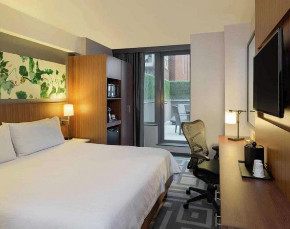 Double bed guest room at the Hilton Garden Inn New York Central Park South Mid-town West, with adjoining patio.