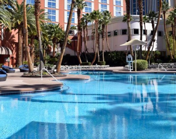 Stunning outdoor pool with seating area at Treasure Island Hotel Las Vegas.