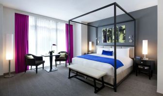 Kind bedroom with seating area at Royalton Park Avenue.