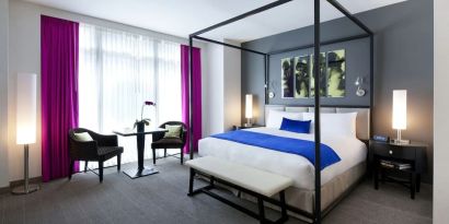 Kind bedroom with seating area at Royalton Park Avenue.