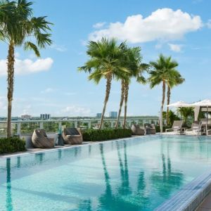 Relaxing pool area with sun chairs at The Altair Hotel Bay Harbor.