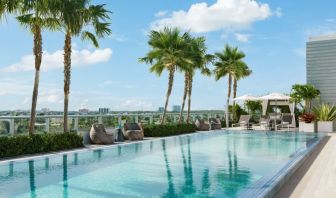 Relaxing pool area with sun chairs at The Altair Hotel Bay Harbor.