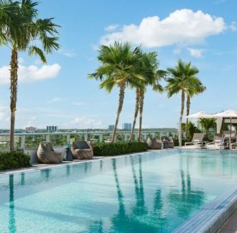 Relaxing pool area with sun chairs at The Altair Hotel Bay Harbor.